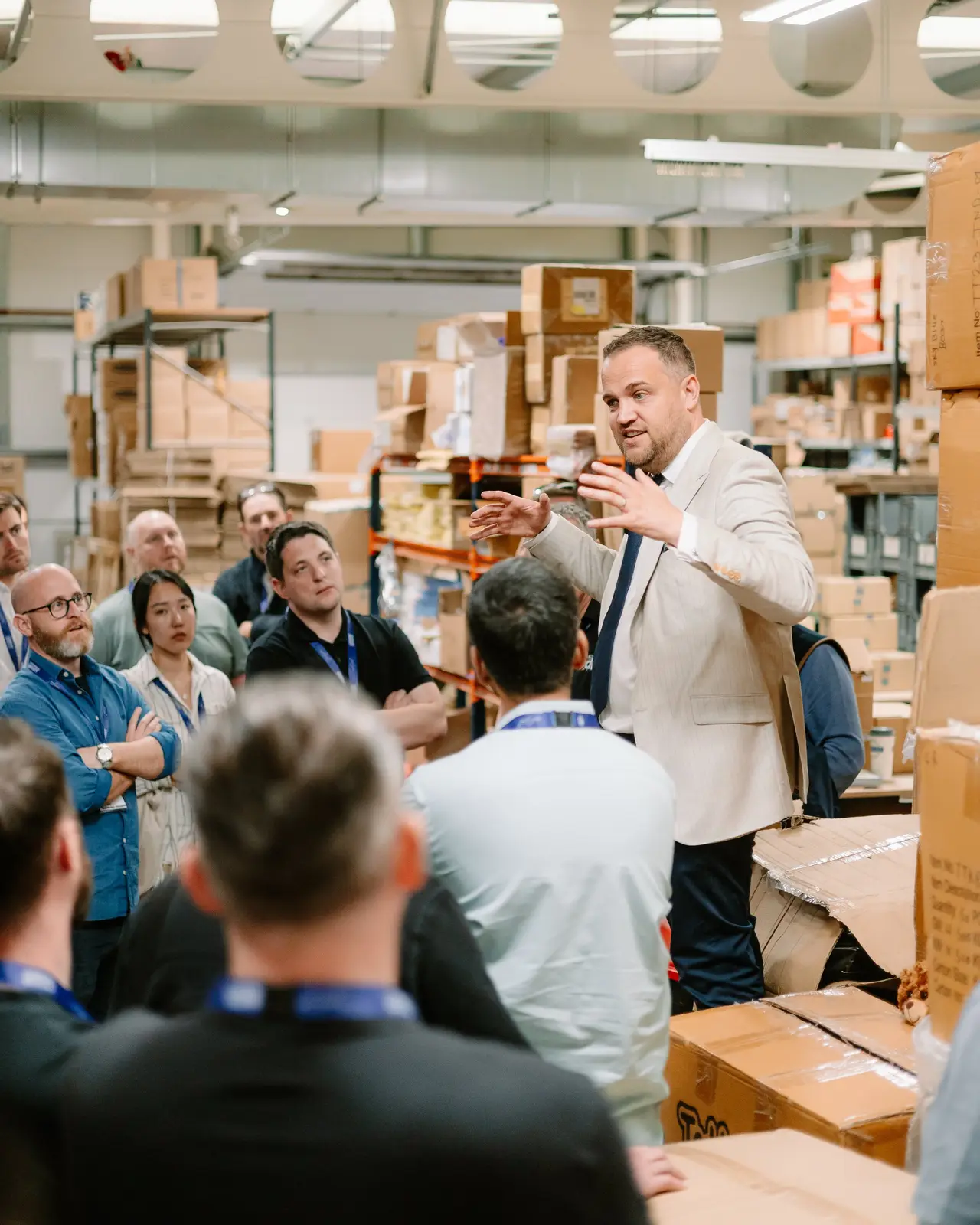 James talking a group of business owners through a warehouse on a site visit